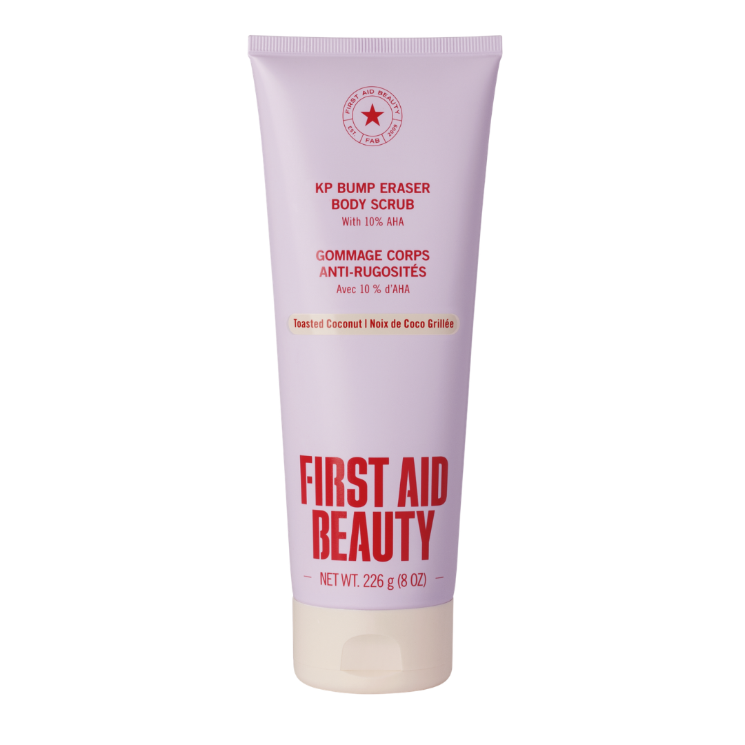A tube of First Aid Beauty KP Bump Eraser Body Scrub, featuring a light lavender-purple body with red and black text, and a white cap, set against a plain white background.
